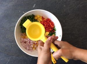 Squeezing in fresh lime juice to make mango salsa