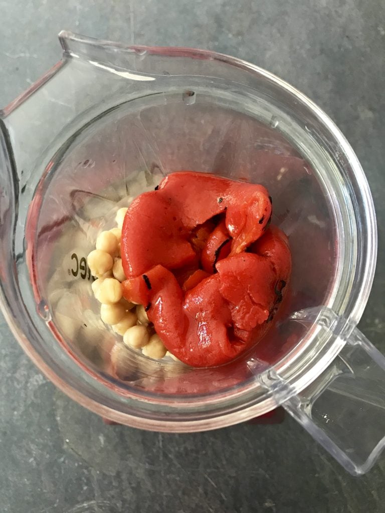 Cooked Chickpeas and red pepper in a blender jar