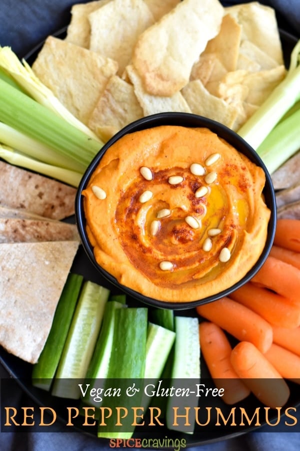 Roasted red pepper hummus garnished with pine nuts and paprika