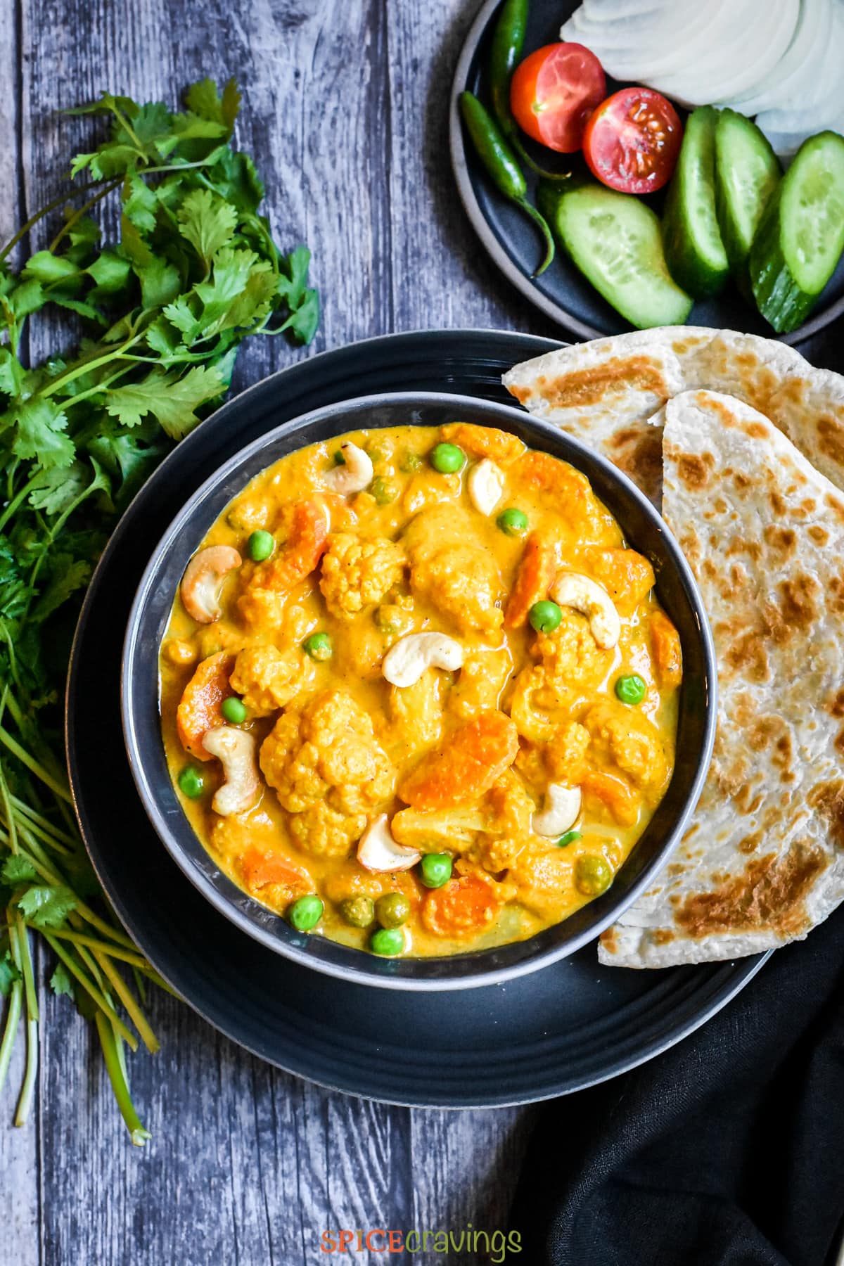 Vegetable Korma served in a bowl with naan