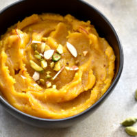 Indian lentil pudding called Moong Dal Halwa garnished with chopped nuts