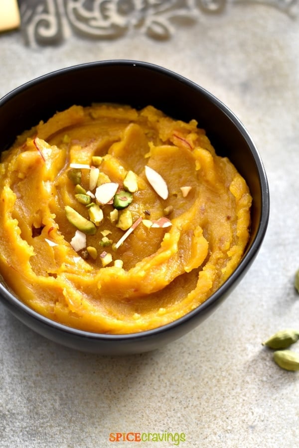 Indian lentil pudding called Moong Dal Halwa garnished with chopped nuts