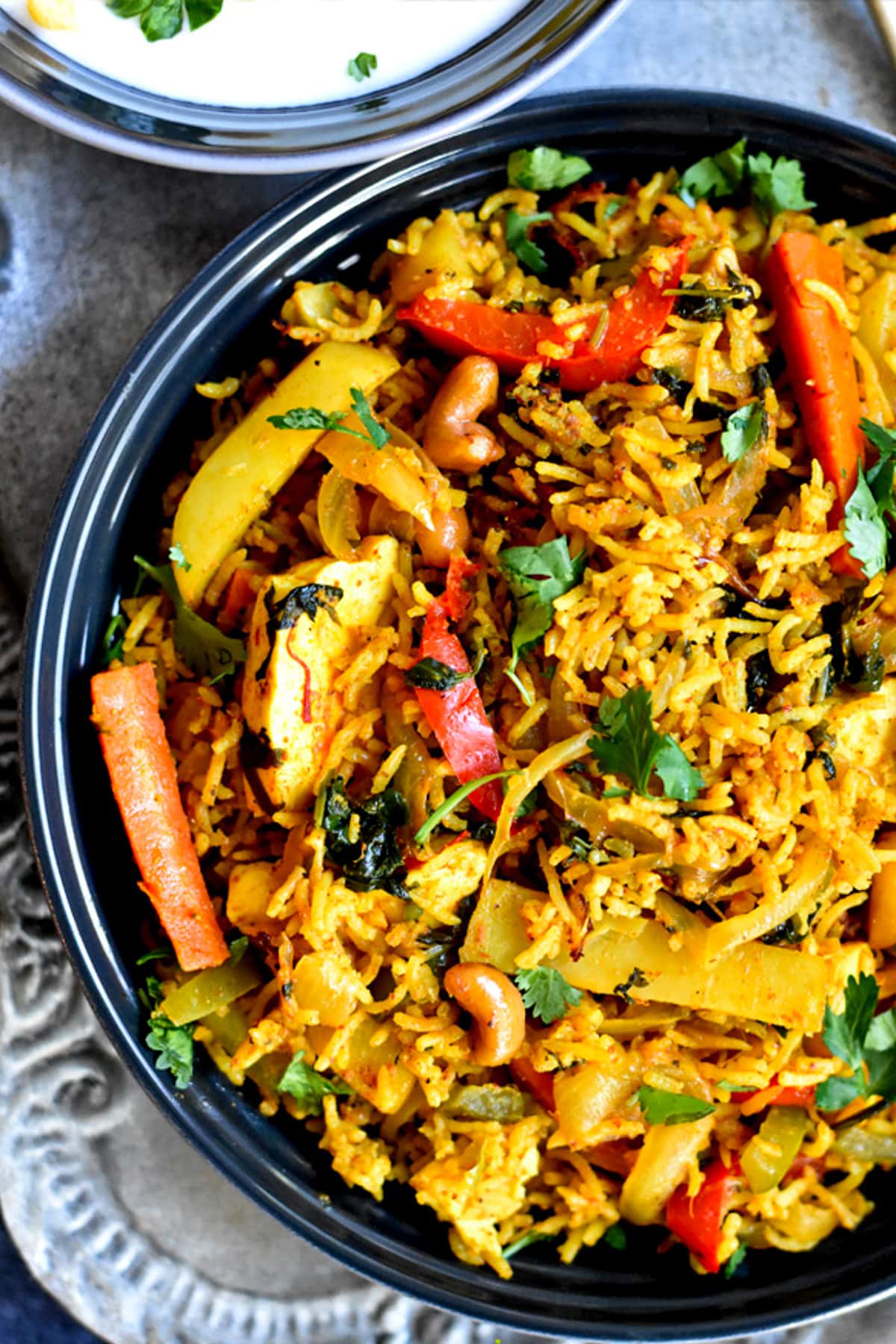 Indian spiced rice and vegetables served in a blue bowl