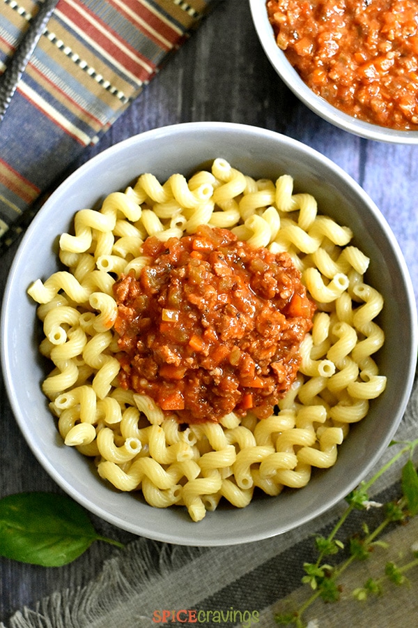Bolognese sauce served over pasta noodles