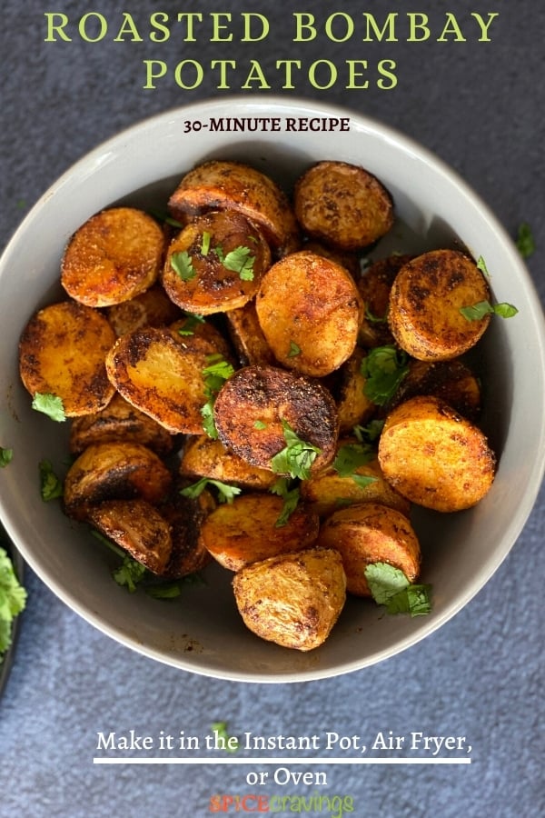 A bowl of crisp roasted bombay potatoes garnished with cilantro