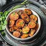 Spiced roasted potatoes in a bowl garnished with cilantro