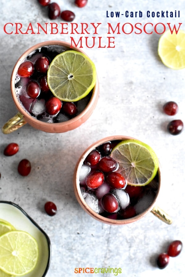 moscow mule topped with cranberries and lime in copper mugs