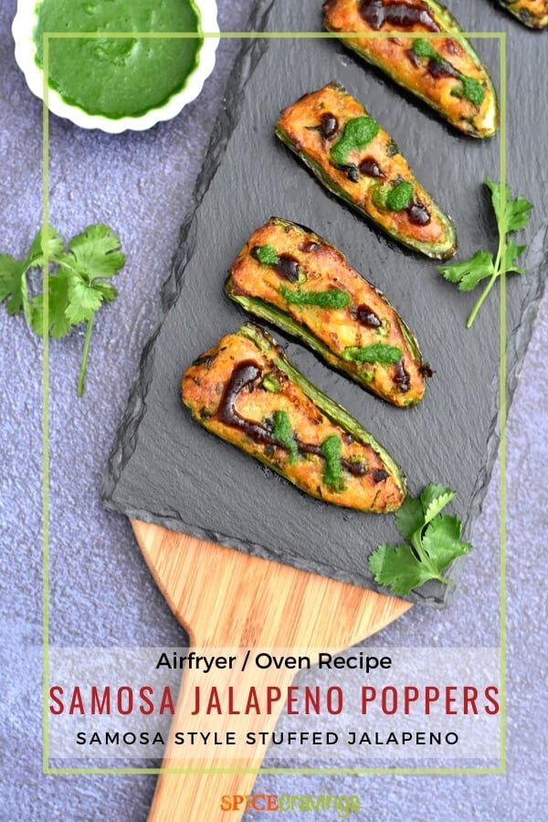 stuffed jalapeno peppers on charcoal board with cilantro chutney in small white bowl
