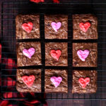 Brownie squares decorated with pink and red icing hearts