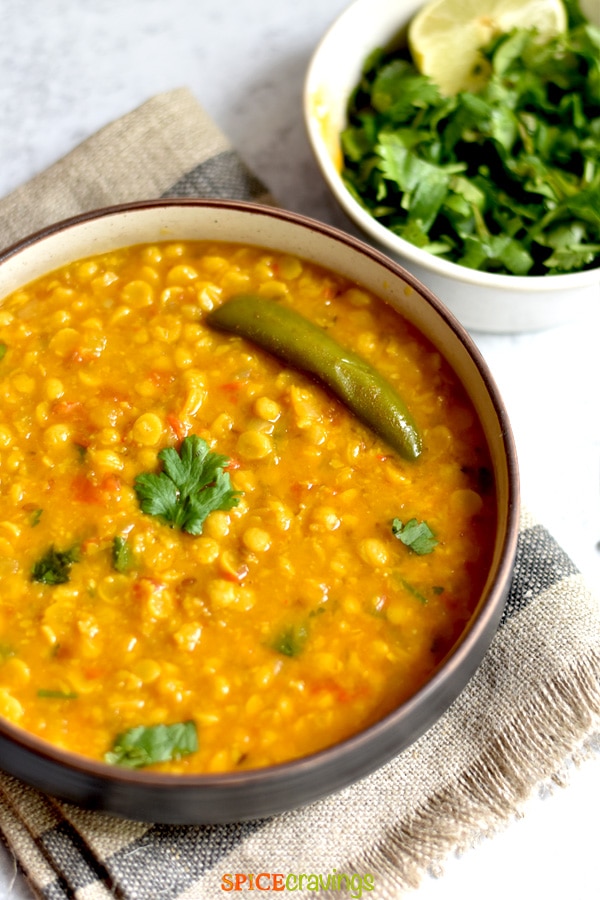 easy split lentil curry with green chili in bowl with fresh cilantro