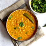 instant pot Indian chana dal with green chili in bowl with fresh cilantro on side