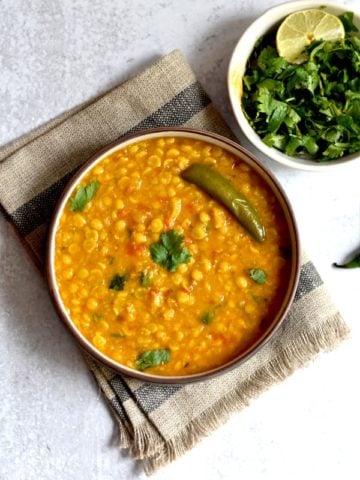 instant pot Indian chana dal with green chili in bowl with fresh cilantro on side