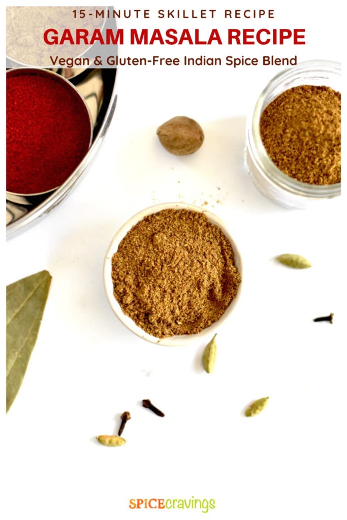garam masala in small white bowl with ground Indian spices in backgroud