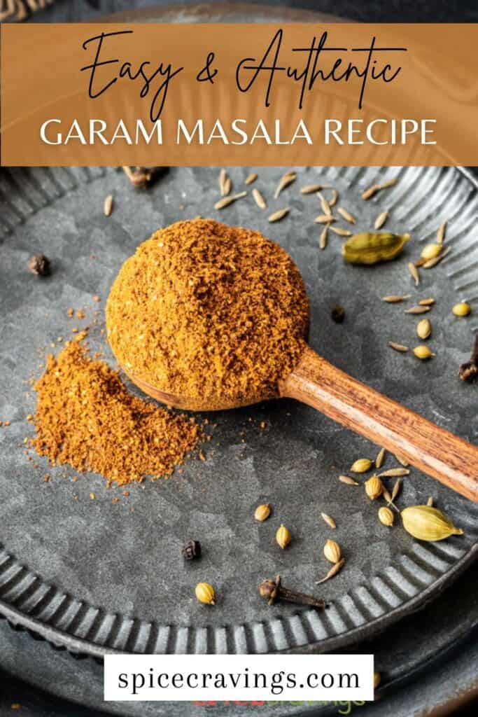 ground garam masala in wooden spoon surrounded by whole spices