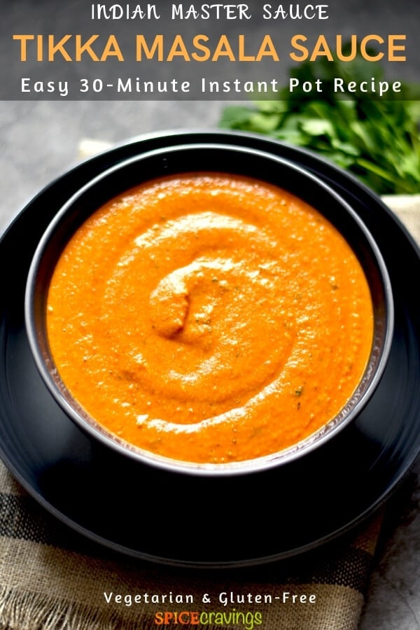 tikka masala sauce in gray bowl on navy blue plate