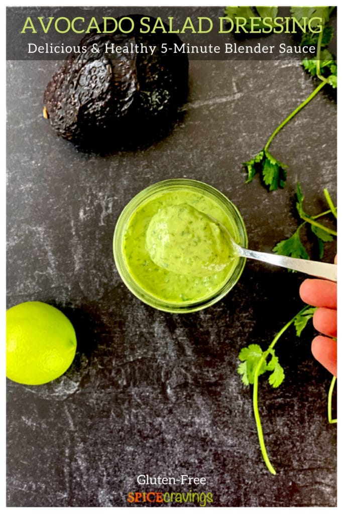 green avocado sauce with spoon and avocado