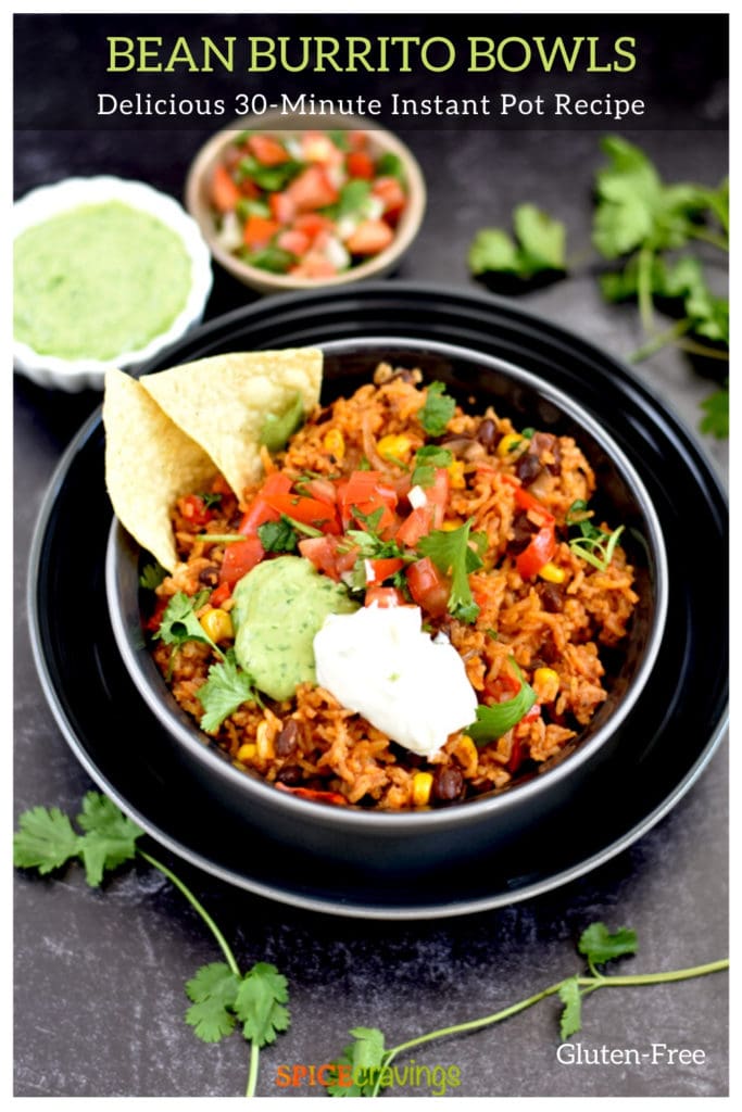 vegetarian rice and black bean burrito bowl in black bowl with tortilla chips and sour cream