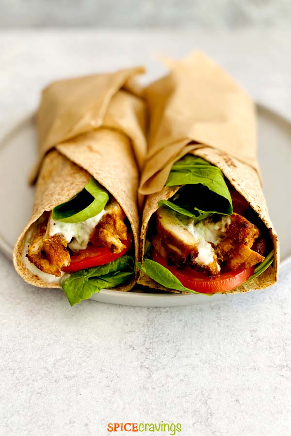 chicken shawarma with lettuce, tomato and tzatziki in wrap