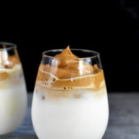 dalgona coffee recipe over milk in two glasses