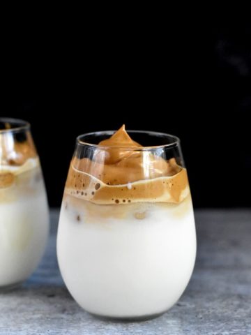 dalgona coffee recipe over milk in two glasses
