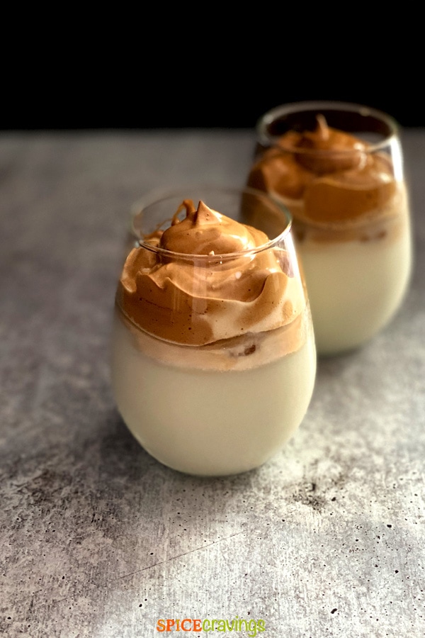 whipped coffee over milk in two glasses