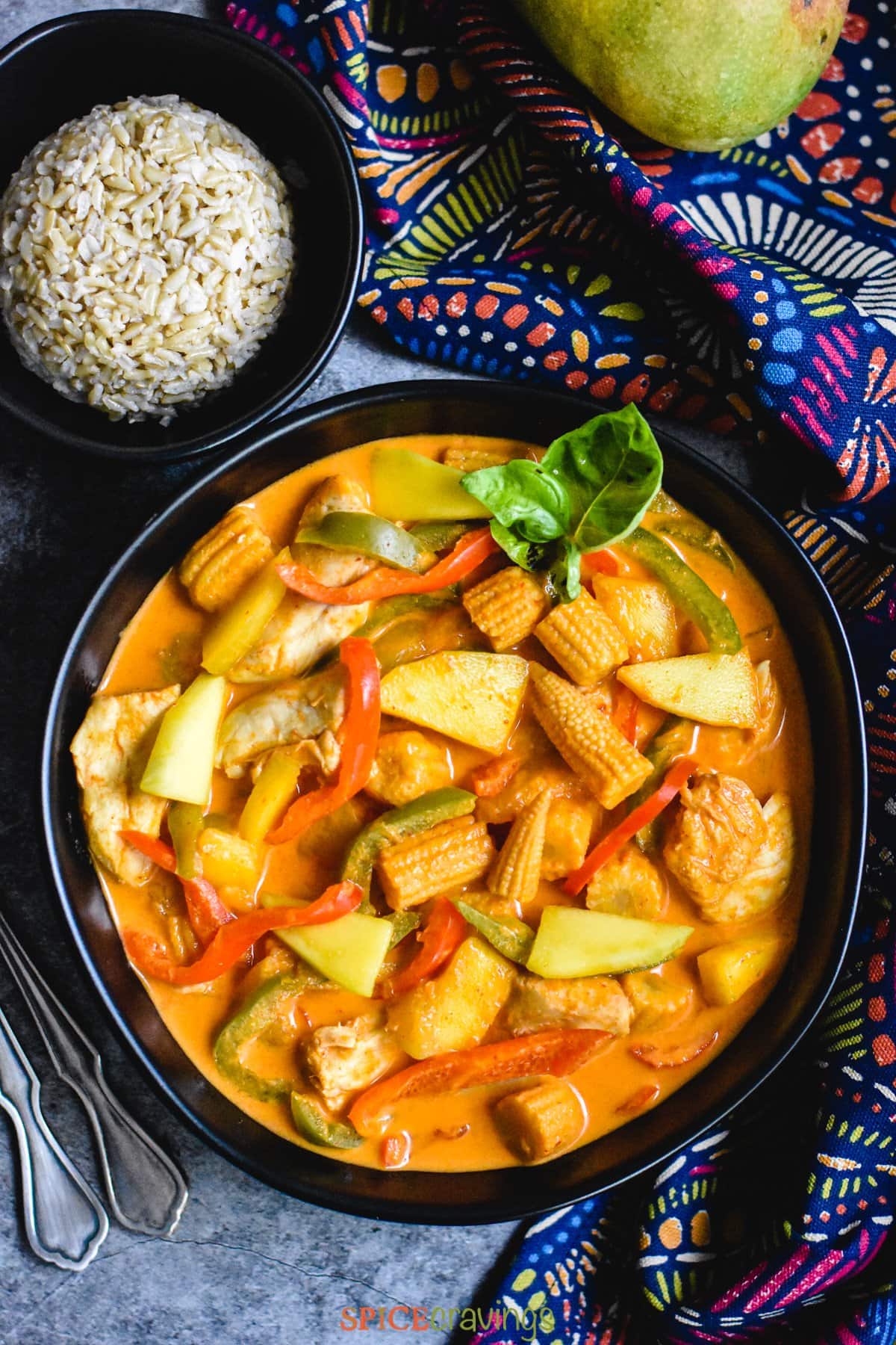 easy Thai red curry in black bowl with side of rice