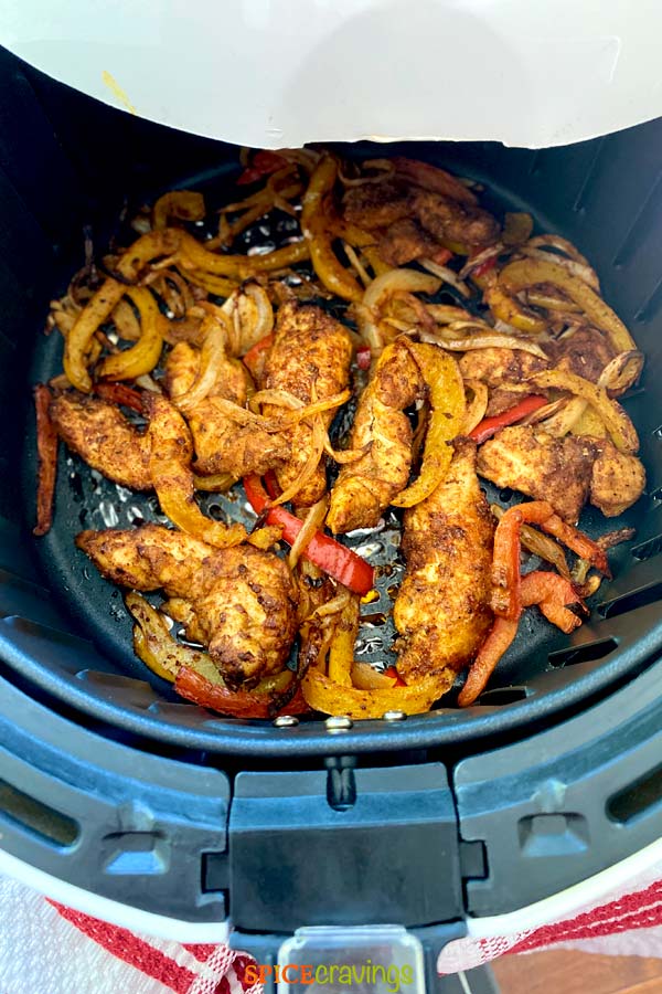 mexican seasoned chicken and vegetables in air fryer basket