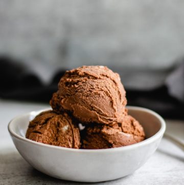 three scoops homemade chocolate ice cream in white bowl