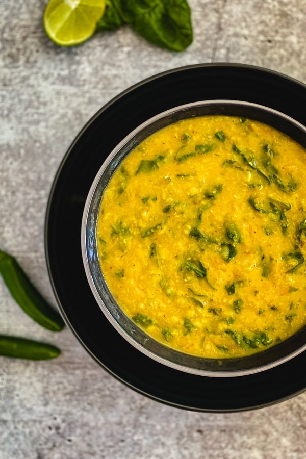 dal with spinach in black bowl