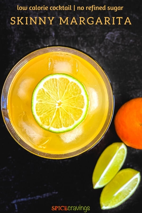 Top view of an orange drink garnished with a lime wheel