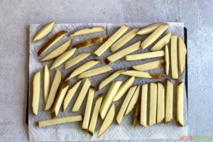Drying raw french fries on paper towels