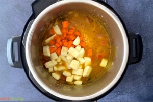 Chopped vegetables, lentils and water in the Instant Pot