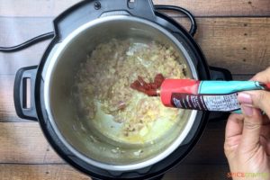 Adding tomato paste in the pot