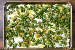 chopped okra with Indian spices on foil lined baking sheet