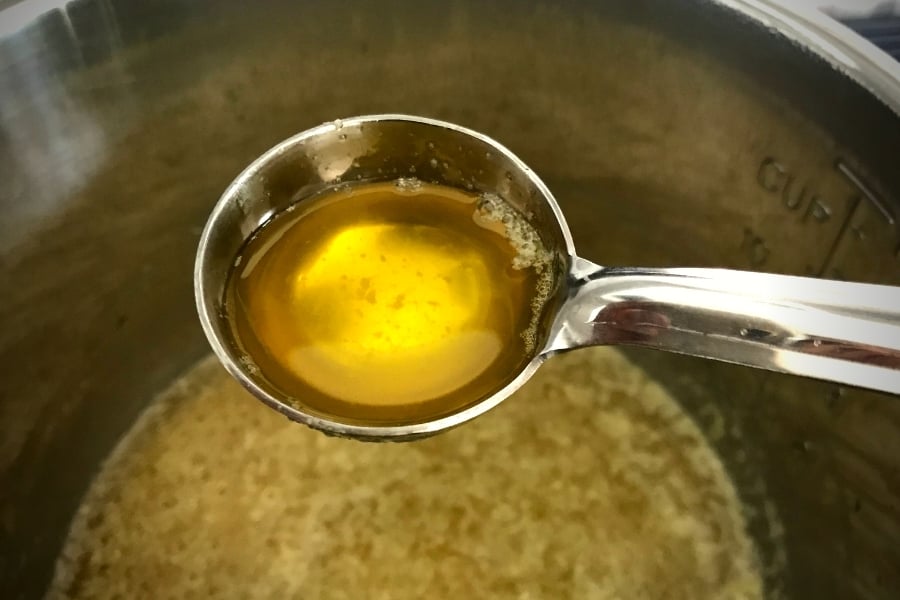 ladle of homemade ghee over instant pot