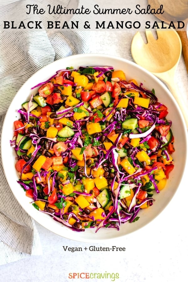mango salad recipe with lime dressing in white bowl with wooden spoon
