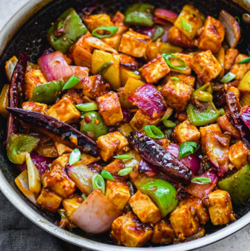 crispy chilli paneer recipe in stainless steel skillet with gray towel