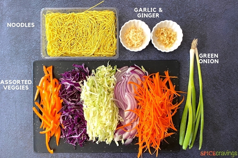 chow mein noodles, minced garlic and ginger, scallions, sliced carrots, onions, green and red cabbage