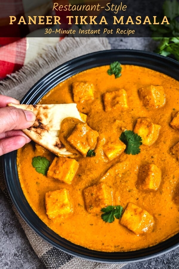 Scooping paneer curry with naan