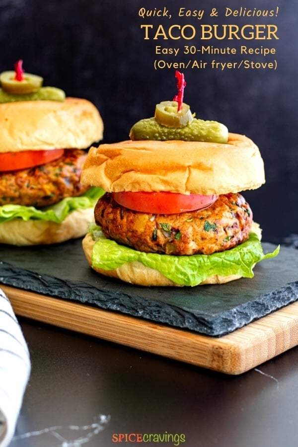 two mexican chicken burgers on buns with lettuce, tomato and skewered with pickle