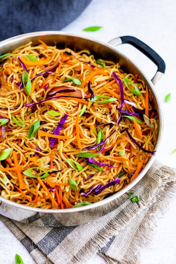 vegetable chow mein recipe in chef pan with towel