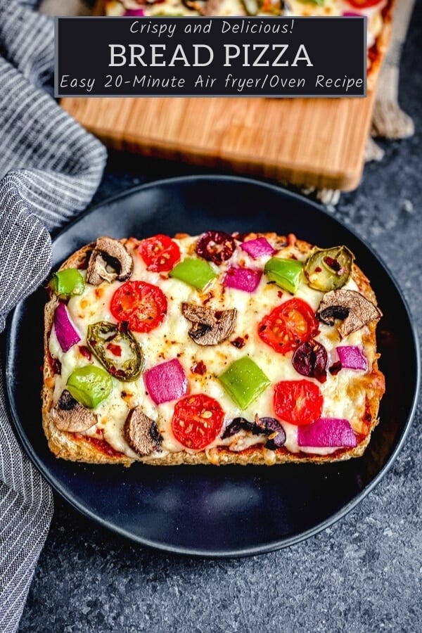 pizza toast recipe with fresh vegetables on black plate with blue napkin