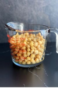 cooked chickpeas in measuring cup