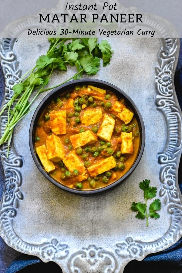 easy matar paneer recipe in black bowl with cilantro sprigs on silver platter