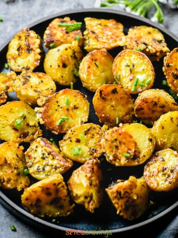 Parmesan crusted baby potatoes garnished with chives