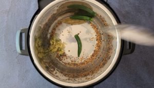 ginger, garlic, serrano chili, pickling spices and bay leaf in instant pot