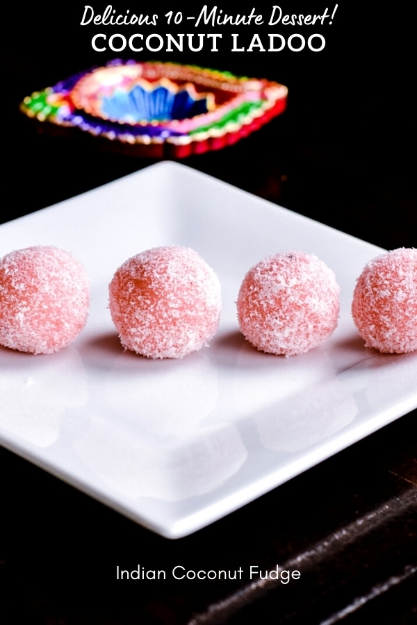five blush pink coconut fidge balls on white plate with black background
