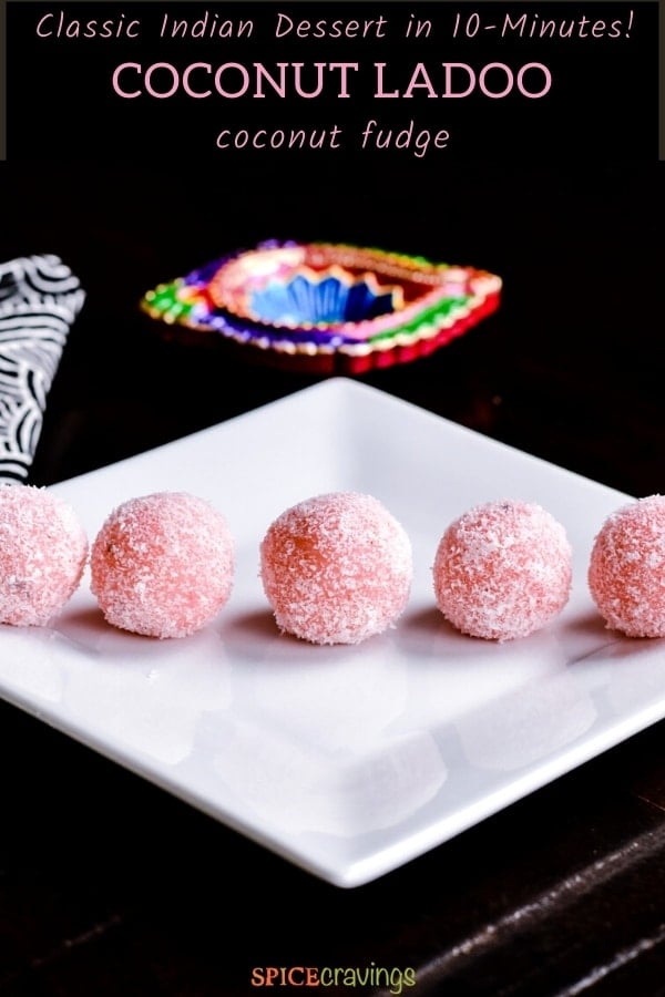five blush pink coconut fidge balls on white plate with black background