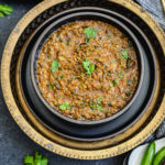 dhaba style keema in black bowl garnished with cilantro sprigs