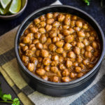 easy punjabi chole recipe in black bowl with lime wedges